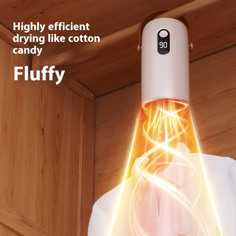 Portable mini clothes dryer drying shirts in a compact apartment