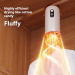 Portable mini clothes dryer drying shirts in a compact apartment